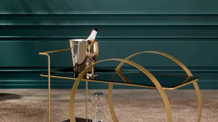 Tavolino carrello di design Venanzio con top in vetro, piano di appoggio in grès porcellanato e struttura in metallo verniciato con finitura oro satinato di Tonin Casa